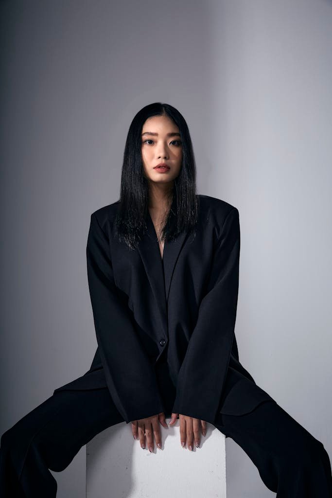 Elegant fashion portrait of a woman in a black suit. Perfect for fashion editorials and lifestyle imagery.