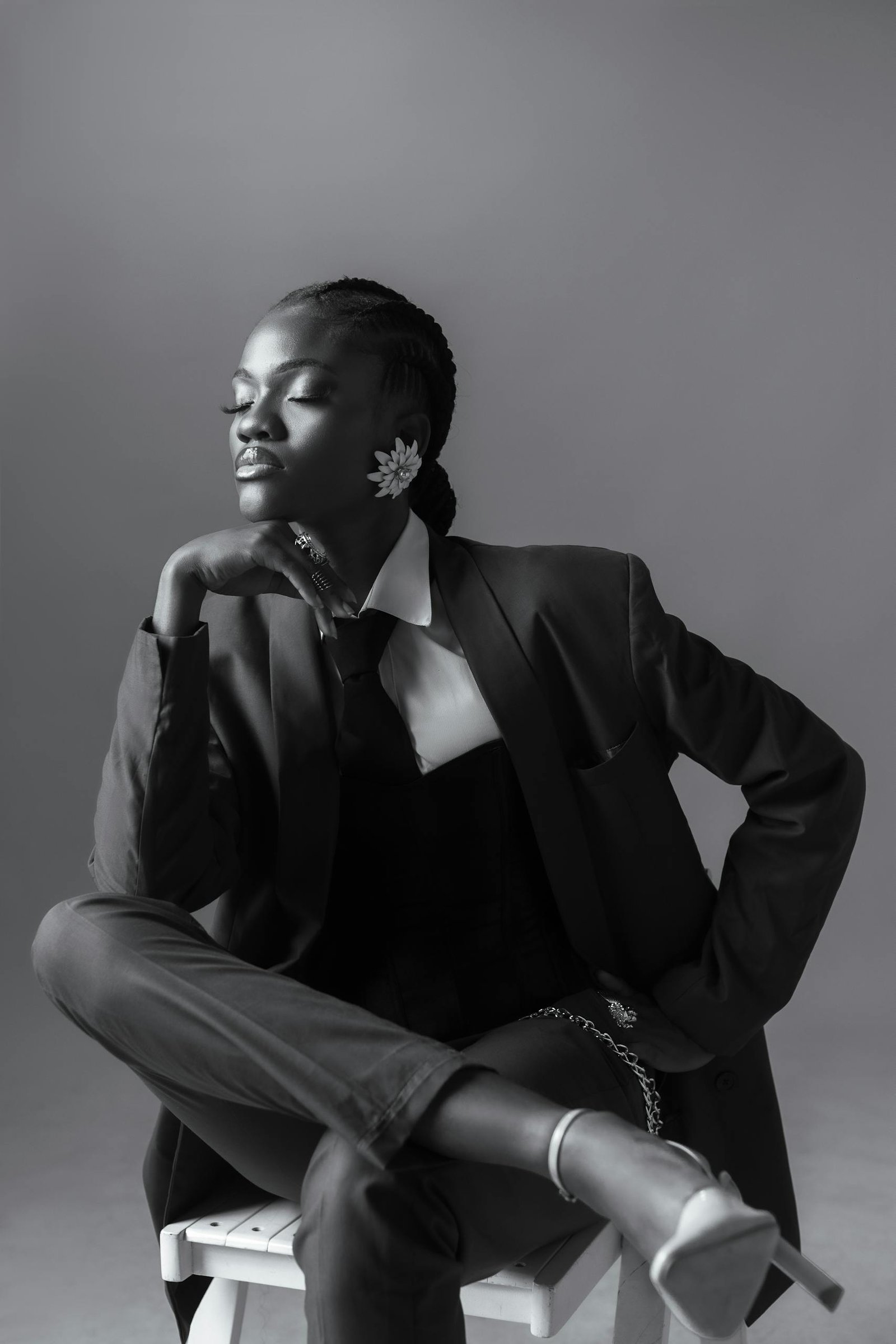 Stylish black and white portrait of a woman in a suit, exuding elegance and confidence.